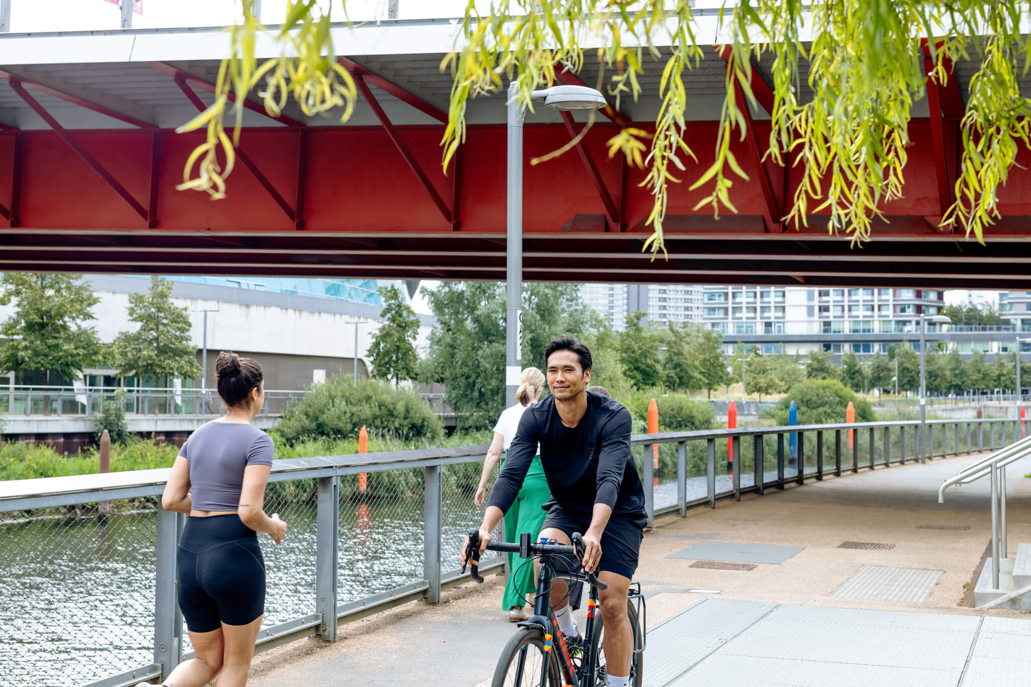 Someone cycling along a bridge