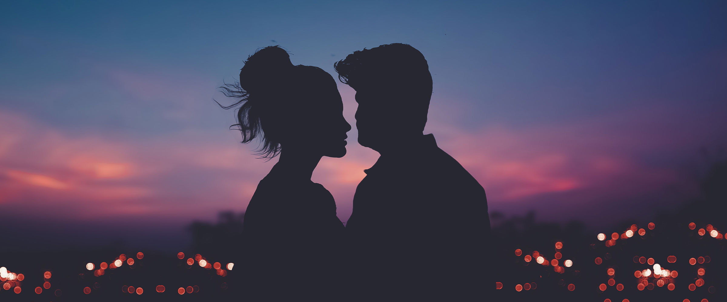 Silhouette of a couple against a sunset.